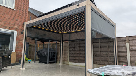 LuxShade™ 3x4m Aluminium Pergola - LEDs, Double-Layer Louvres & 3 Windscreens - Oak Effect