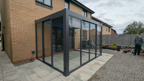 EdgeShade™ 3m x 4m Wall-Mounted Aluminium Pergola, Louvred Roof, RGBW LEDs & 3 Zip Windscreens - Grey